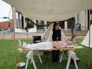 Preparing a body for burial, the embalmer shares history with the public  